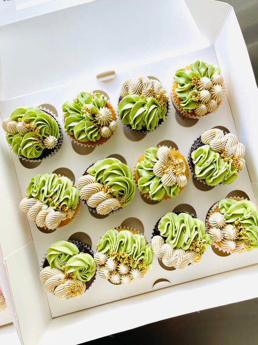 pretty floral design piped cupcakes with gold finishes