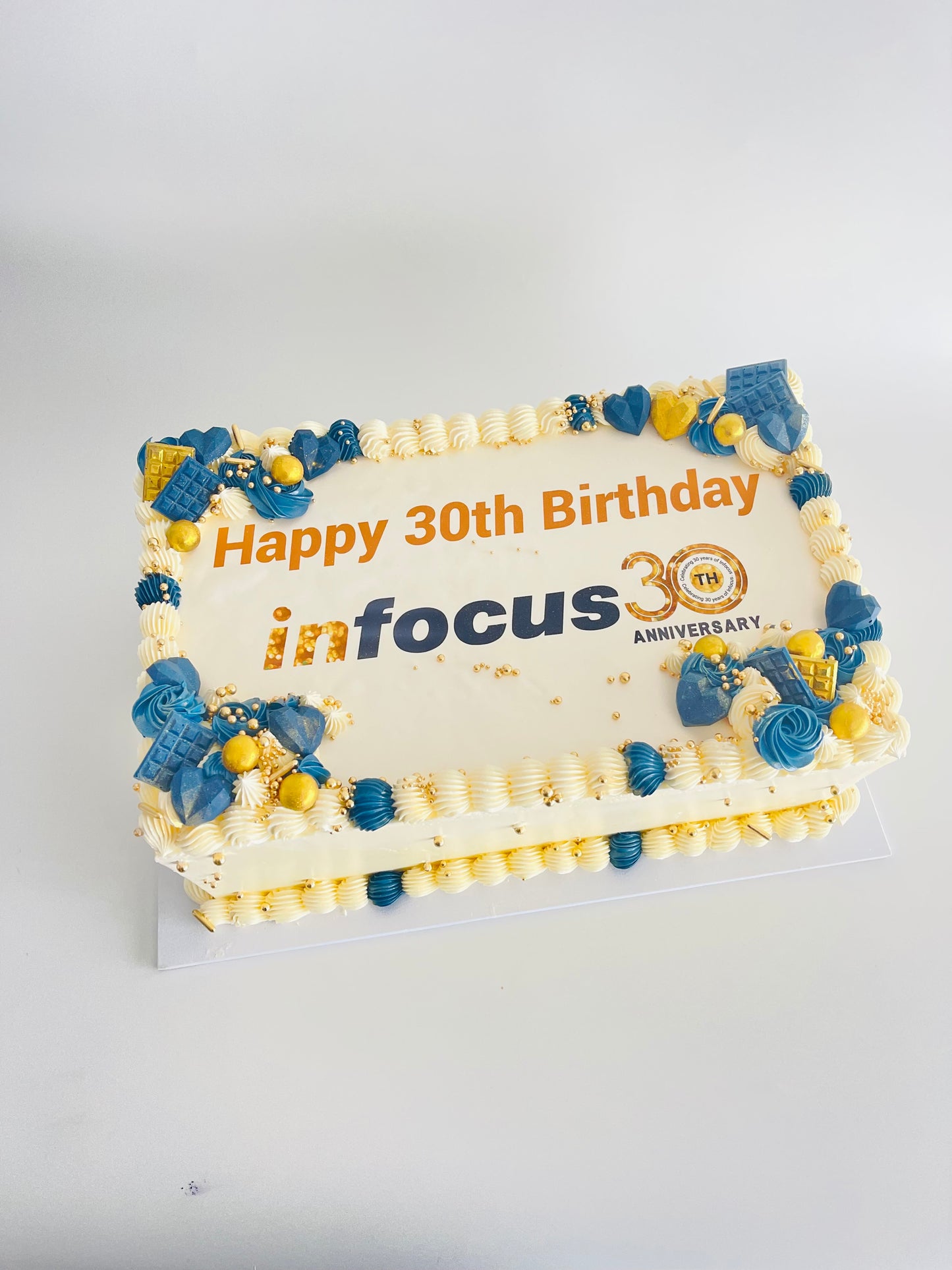 rectangle cake with office logo, message and matching decorations