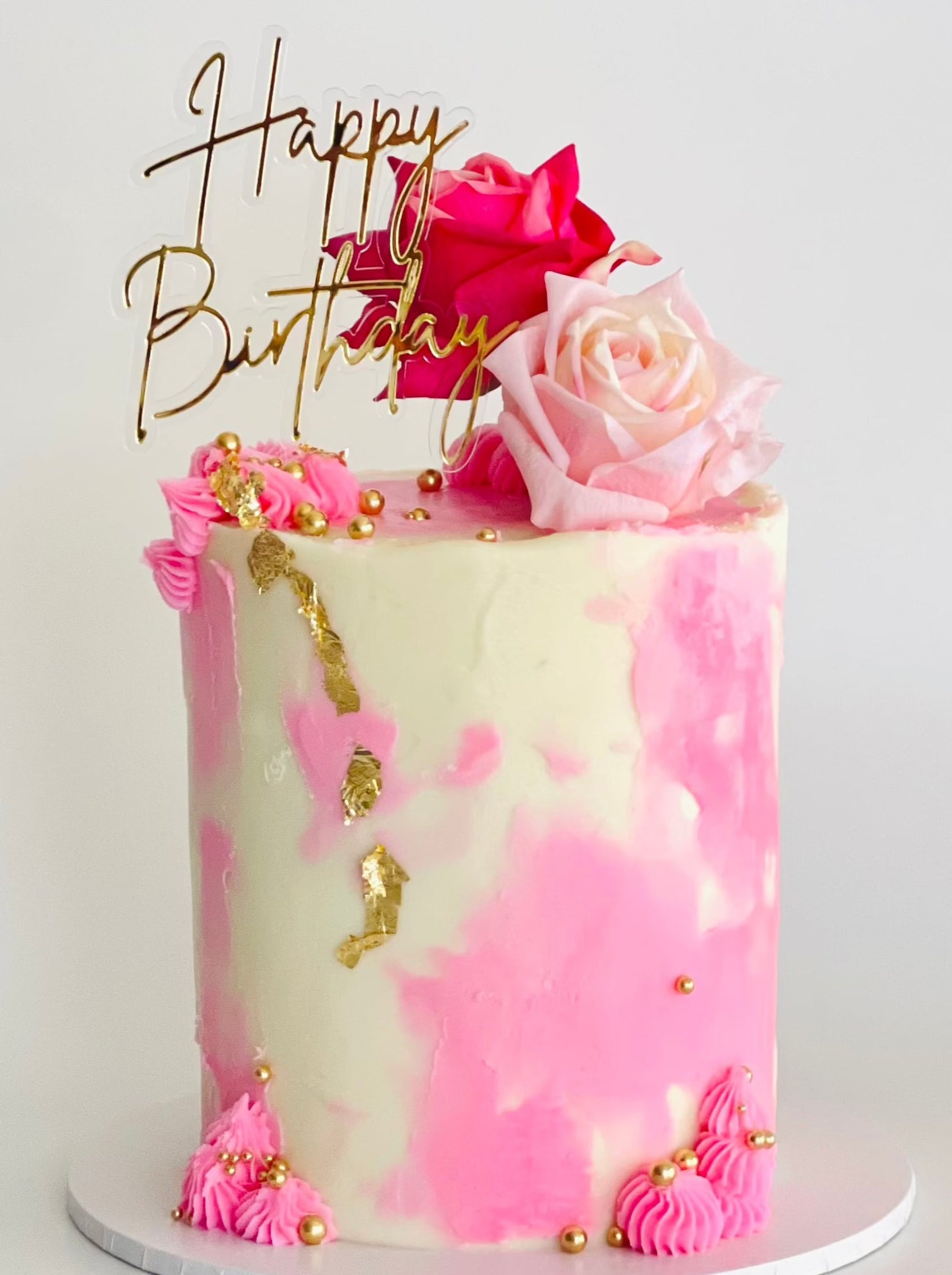 Pretty cake with pink finishes and pink roses perfect for any celebration or a gift