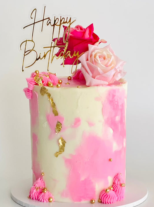Pretty cake with pink finishes and pink roses perfect for any celebration or a gift