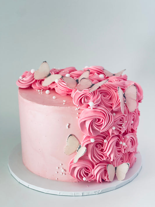 Beautiful pink cake with pretty swirls and delicate butterflies