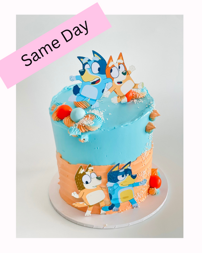 Bluey theme cake with characters on a  blue & orange cake. Available to order for same day pick up or delivery