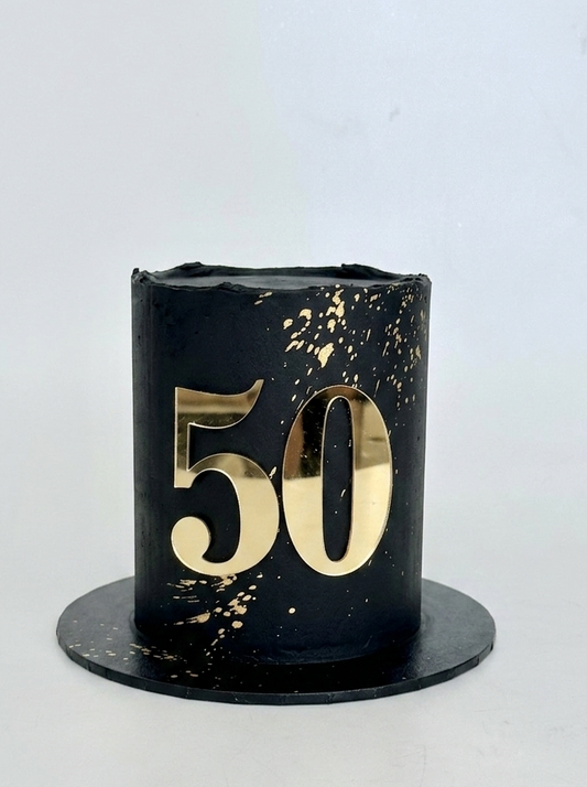 Black cake with gold number 50 and gold splatter