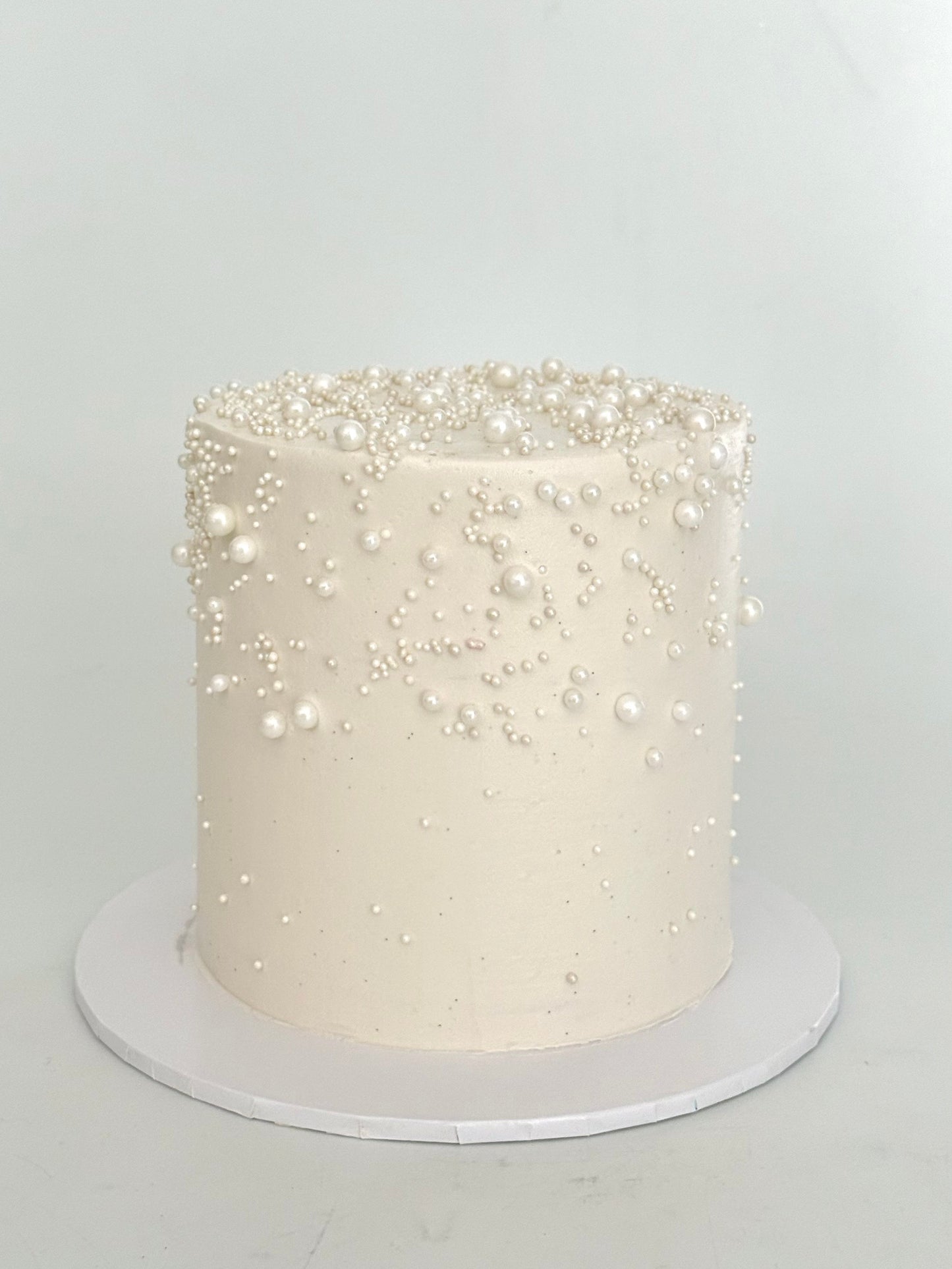 white cake with pearls