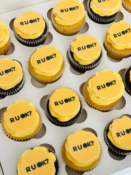 Cupcakes with R U Ok on top of them in golden yellow