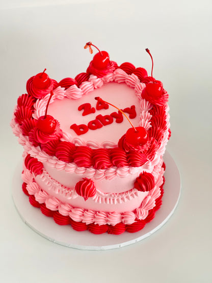 Vintage heart cake with colorful piping, cherries, and sprinkles