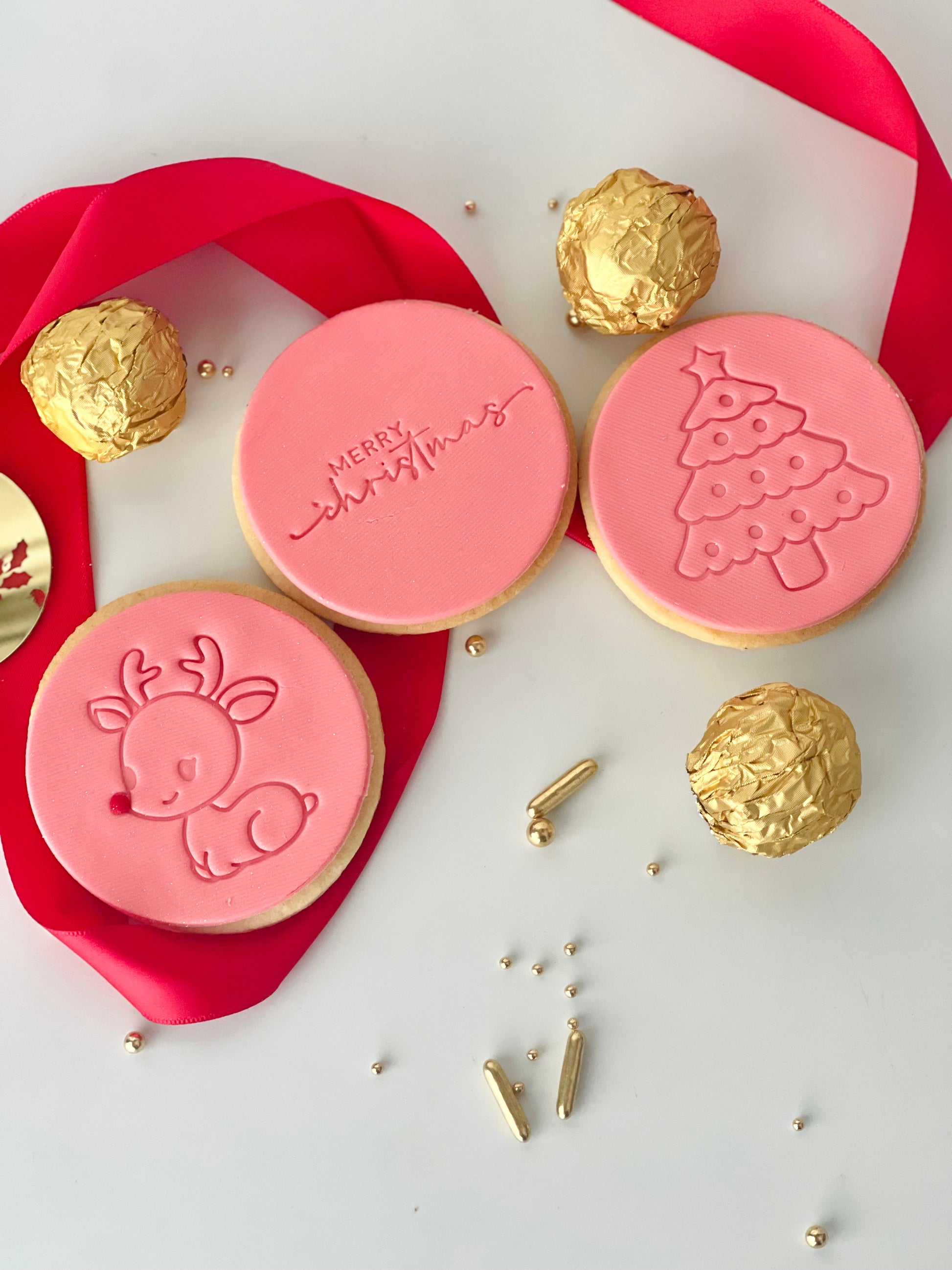 christmas themed cookies with stamped design of reindeer, tree & Merry Christmas. Cute little set & perfect as a gift or stocking filler